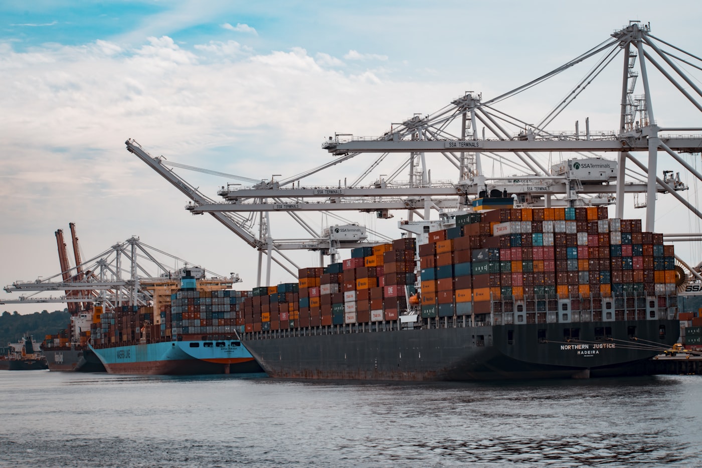 Container vessels alongside at a terminal with gantry cranes